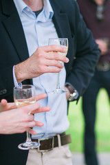 A man holds a glass of wine