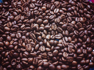 macro shot of the coffee beans on the plate background 