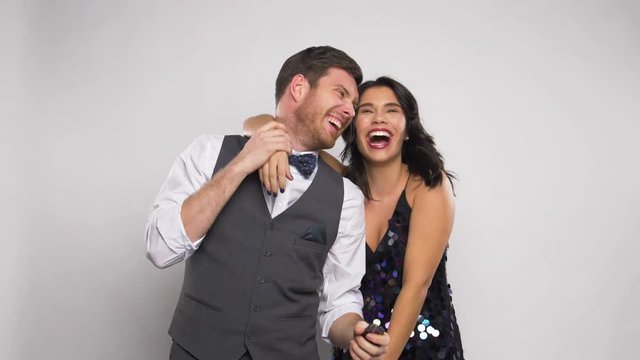 happy couple with party poppers having fun