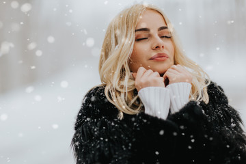 Pretty young blonde woman at winter day