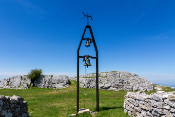 Fototapeta na wymiar Bell And Cross On Top Of Monte Labbro