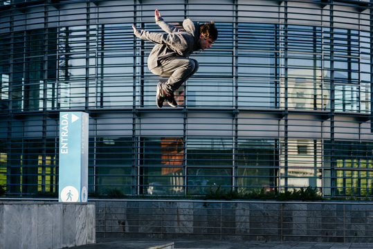 Man performing parkour on building terrace