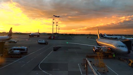 Huge jet crossing sun at sunset