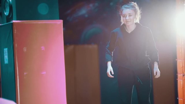Two woman in trampolin acrobatic hall plays ball, slow-motion