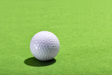 Golf ball on a green grass background