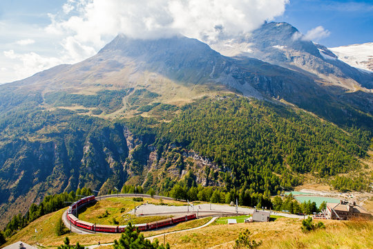 train in the scenic swiss alps around bernina and moteratsch glacier