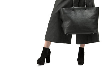 Girl with a big black bag and high-heeled shoes