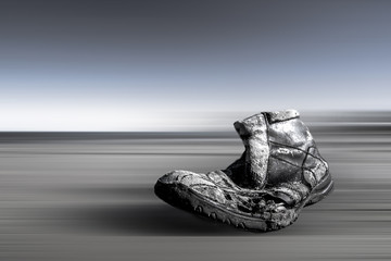 Searuined lost shoe on the coast with motion blurred background.
