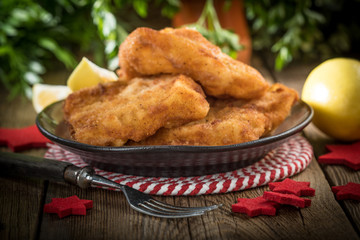 Fried cod slices in breadcrumbs.
