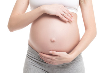 Close-up of pregnant woman touching her belly