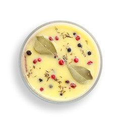 Chicken liver pate in jar covered with melted butter and decorated with bay leaves and black and red pepper isolated on white background. Top view.