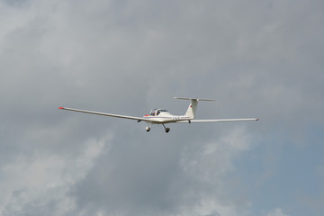 Fototapeta na wymiar white airplane on the cloudy sky