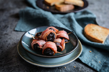 Roasted dried plums wrapped in bacon