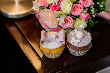 Gourmet holiday cupcakes with bouquet of roses