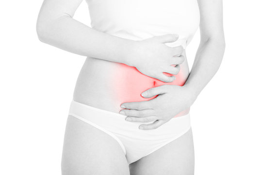 Young woman suffering from abdominal pain red area on white, clipping path