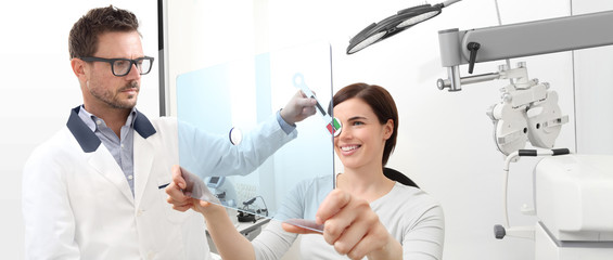 optometrist examining eyesight, woman patient pointing at the hole on plexiglass, ocular dominance test - obrazy, fototapety, plakaty