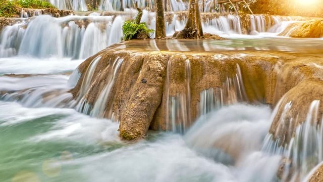 Fly over fantasy mysterious forest stream time lapse. Magic beautiful waterfall in the heart of the green enchanted forest