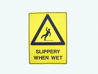   A warning sign depicting someone falling over due to it being slippery when wet
                     