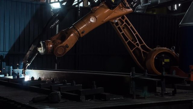 Timelapse of welding robot arm melt metal process at workshop. High Precision Modern Tools in Heavy Industry. Automatic work. Technology and Industrial Concept. Shot in 5K RAW