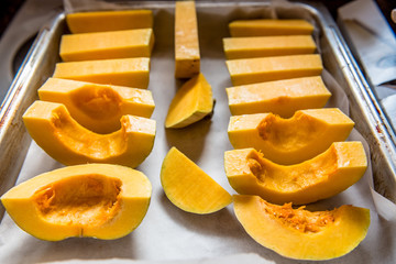 Fresh pumpkin peaces ready to be put in oven and roasted