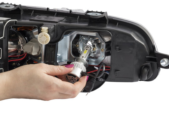 Woman Hand Installing H7 Led Headlight Bulb