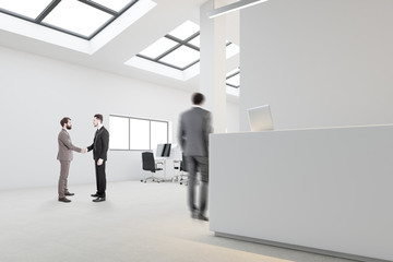 White reception in open space office, businessmen