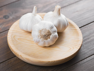 Garlics on round wooden board. Food