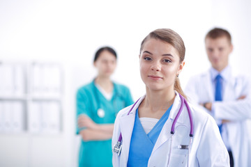 Fototapeta premium Attractive female doctor in front of medical group.
