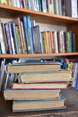five old books in a library