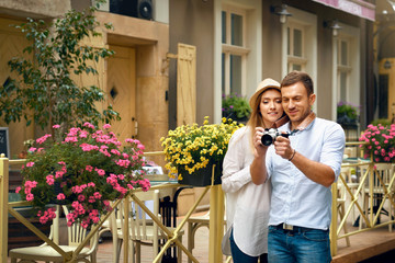 Traveling Couple Taking Photos With Camera In City Street.