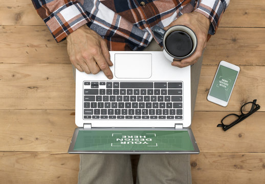 Top View of Laptop and Smartphone User on Floor Mockup 1