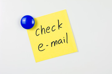 check email note reminder yellow sticker on the white  fridge door attached blue round magnet,...