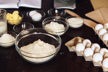 Baking ingredients on kitchen table. White products prepare for cooking. Lifestile food concept.