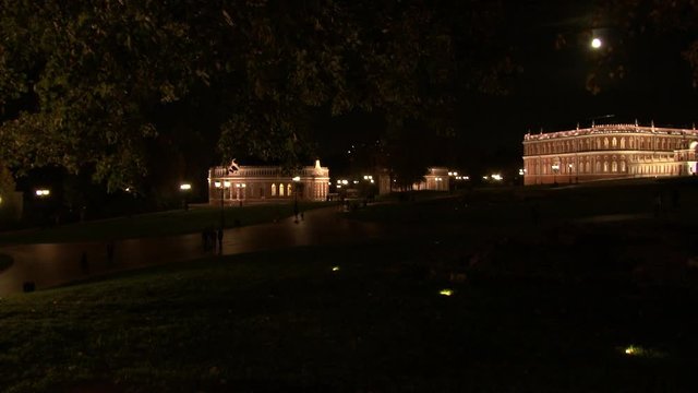 People walk near towers and fortresses of red brick in Tsaritsyno at night. Family holiday at weekend in parks and museums of capital Russia Moscow,