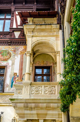Balcony and mural painting on an inner courtyard wall at the Peles Castle in Romania