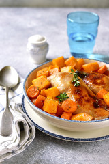 Roasted chicken legs with pumpkin and carrot.
