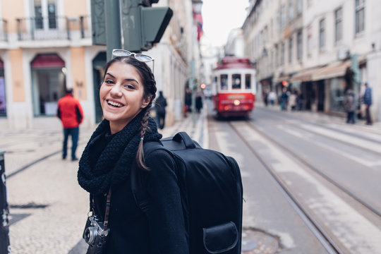 Female traveler woman walking streets of European capital.Visitor in Lisbon,Portugal.Traveling Europe on a budget.Studying abroad.Student discount for traveling concept