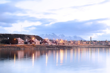 Village on river at sunset.