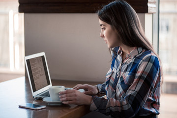 girl working with laptop in cafe