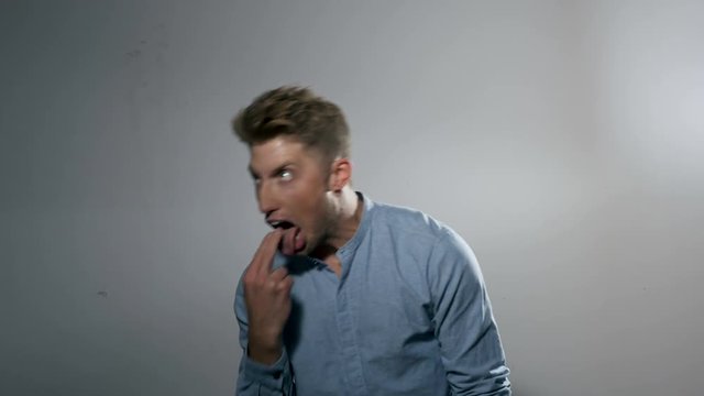 Portrait of a Male Model: Throwing Up Facial Expression and Gesture