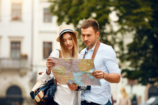 Couple With Map On Travel Vacations, Sightseeing