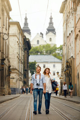 Fototapeta na wymiar Travel. Tourist Couple Traveling, Walking On Street