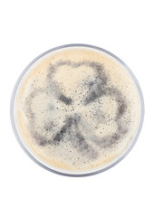 Glass of stout beer top with shamrock shape
