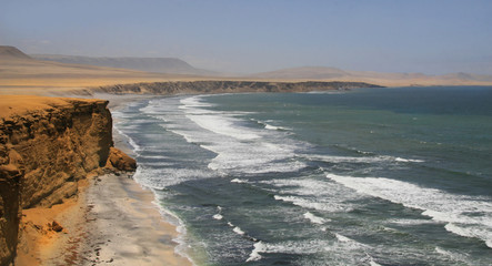 View of the Pacific ocean and the desert coast and cliffs of Paracas, Peru
