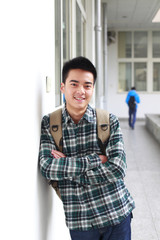 portrait of young man smile at camera in campus
