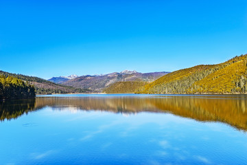 Fototapeta na wymiar Landscape of Shangri-La in early spring, Shudu Hai Lake. Pudacuo National Park. It is a national park located in Shangri-La, Yunnan, China.