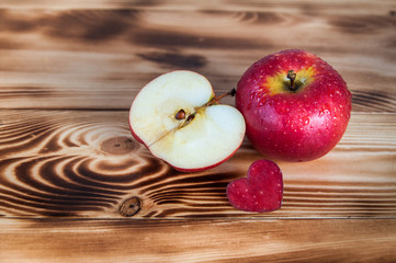 Red appes and cut out heart on burned boards