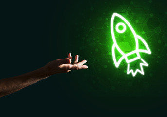 Man palm presenting Rocket web icon as technology concept