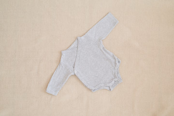 newborn baby clothes - studio shot from above
isolated little silk body on natural woolen background