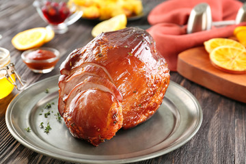 Metal plate with traditional honey baked ham on table